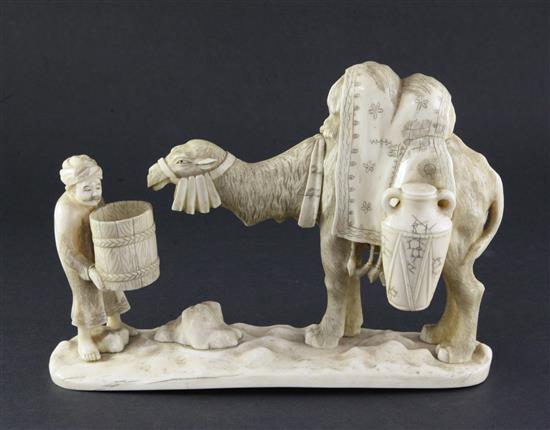 A Japanese sectional walrus ivory okimono of a Bactrian camel and a man, early 20th century, length 26cm